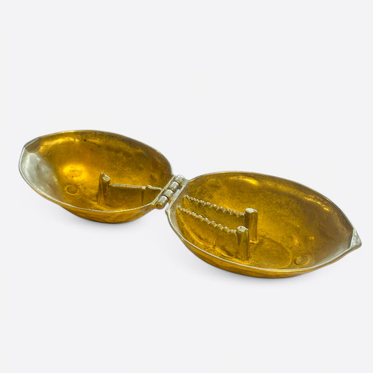 Vintage brass nutcracker in the shape of a walnut