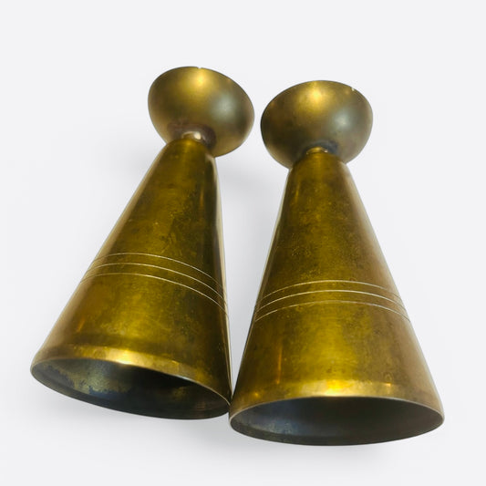 A pair of brass assumed candle holders